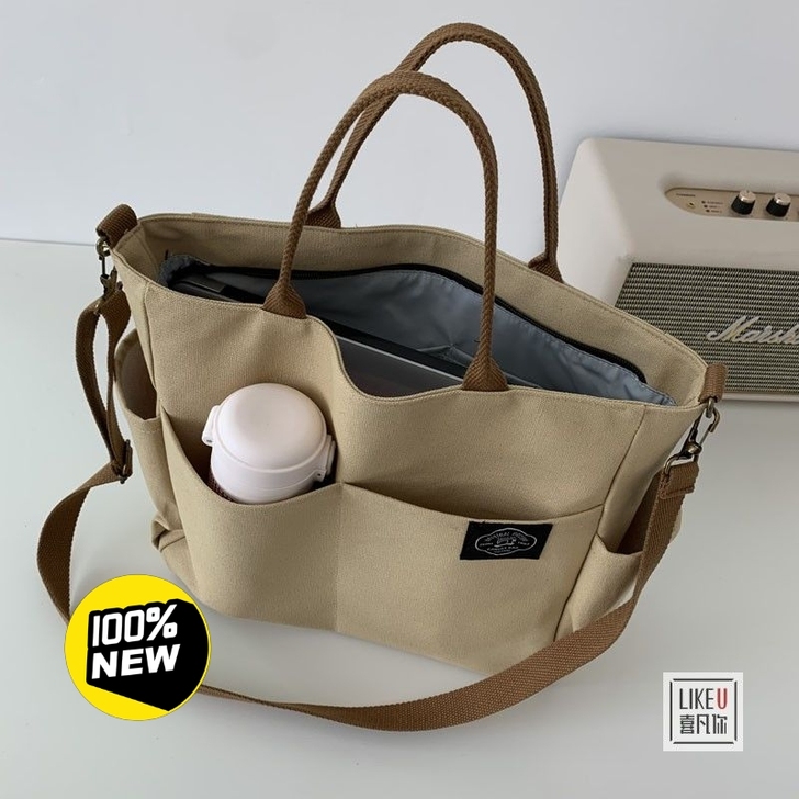 日系原创多口袋托特帆布包简约百搭文艺大容量...